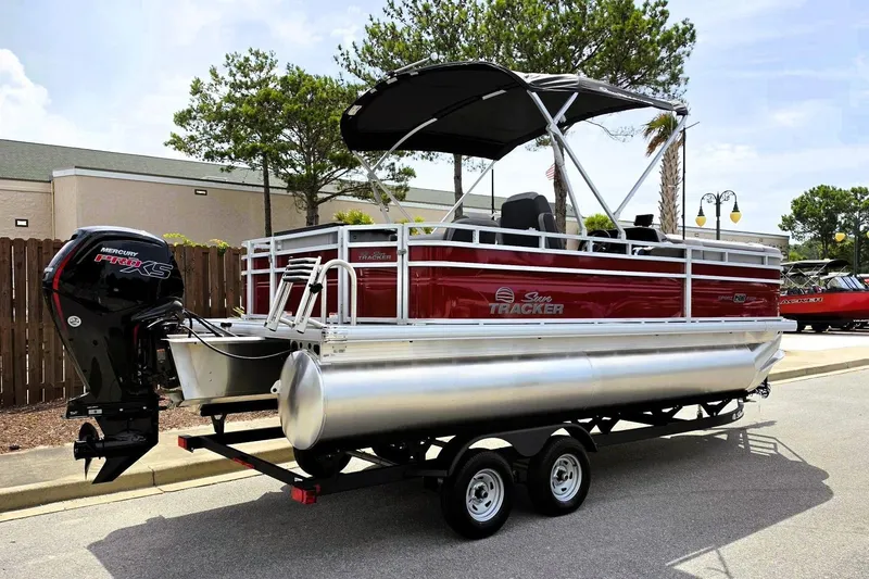 Slide: The Image of 2026 Sun Tracker SportFish 20 DLX pontoon boat with Mercury Pro XS engine on trailer. - 2