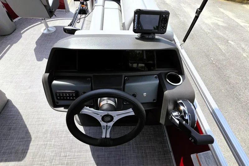 Slide: The Image of 2026 Sun Tracker SportFish 20 DLX boat dashboard with steering wheel and control panel. - 14