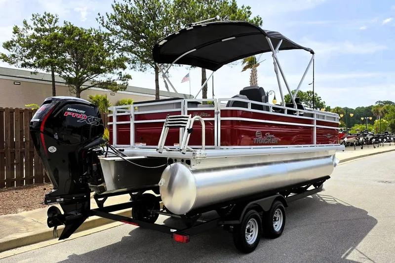 Slide: The Image of 2026 Sun Tracker SportFish 20 DLX pontoon boat on trailer, featuring Mercury Pro XS engine. - 3