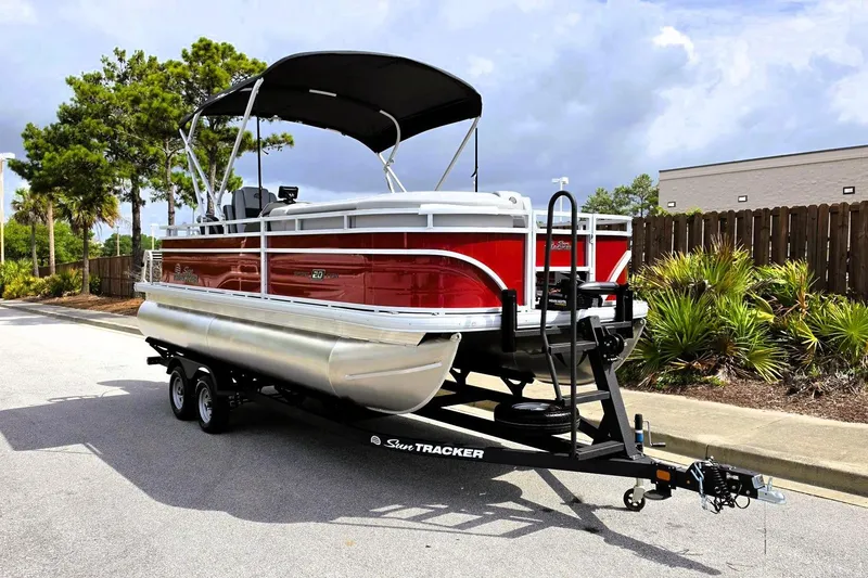 Slide: The Image of 2026 Sun Tracker SportFish 20 DLX pontoon boat on trailer, parked outdoors. - 5