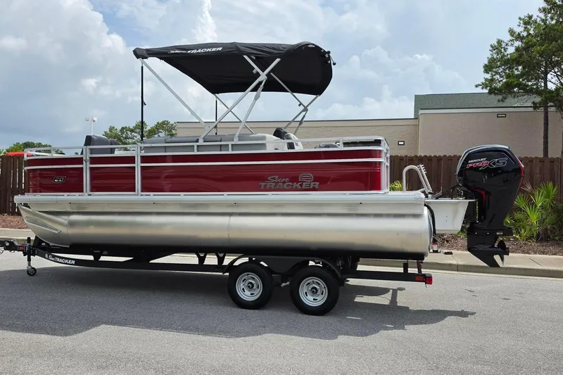 Slide: The Image of 2026 Sun Tracker SportFish 20 DLX pontoon boat with canopy and outboard motor. - 10