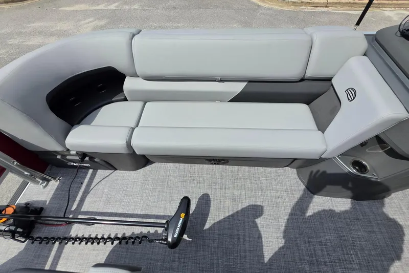 Slide: The Image of 2026 Sun Tracker SportFish 20 DLX boat interior with gray seating and trolling motor. - 20