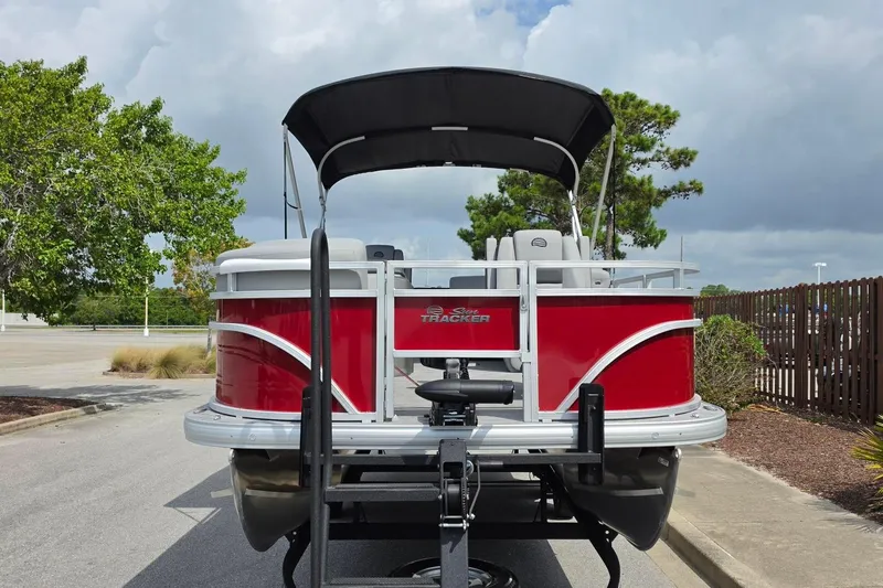 Slide: The Image of 2026 Sun Tracker SportFish 20 DLX pontoon boat with red exterior on a trailer. - 7