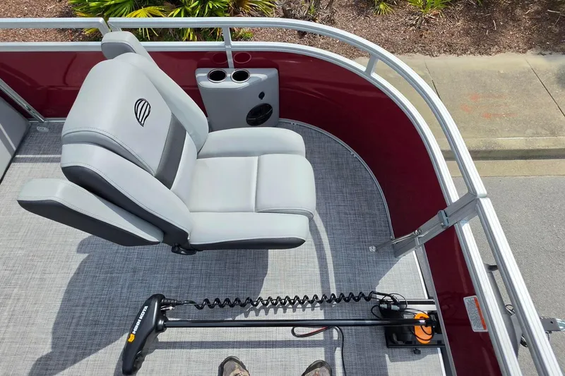 Slide: The Image of 2026 Sun Tracker SportFish 20 DLX boat interior with gray seating and trolling motor. - 19