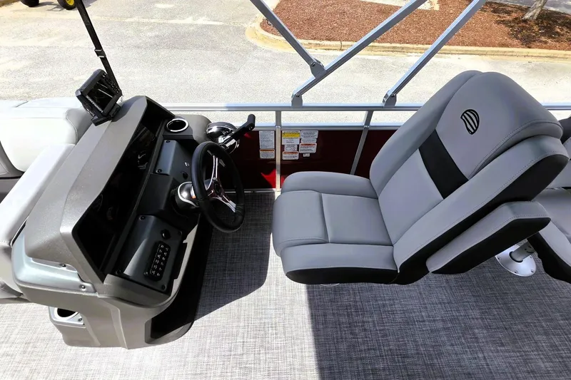 Slide: The Image of 2026 Sun Tracker SportFish 20 DLX boat interior with steering console and comfortable seating. - 13