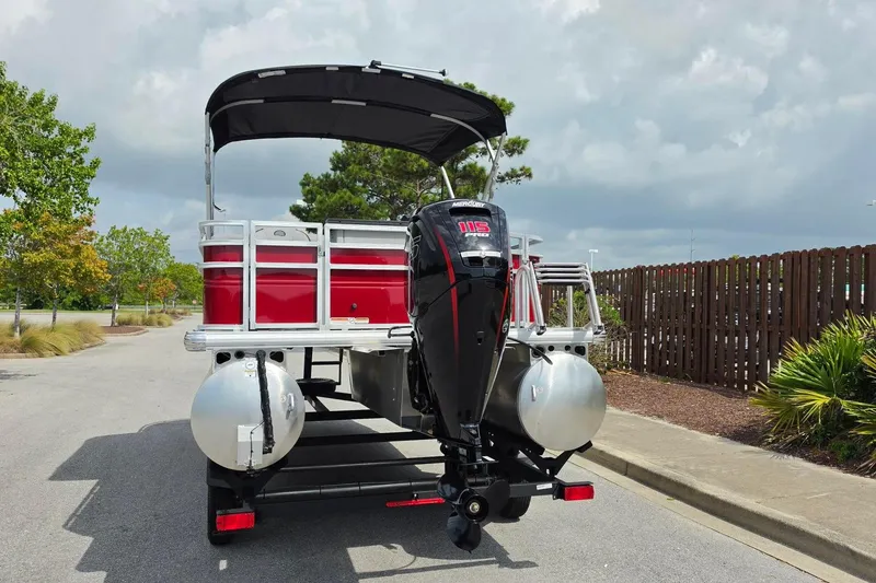 Slide: The Image of 2026 Sun Tracker SportFish 20 DLX pontoon boat with Mercury outboard motor on trailer. - 12