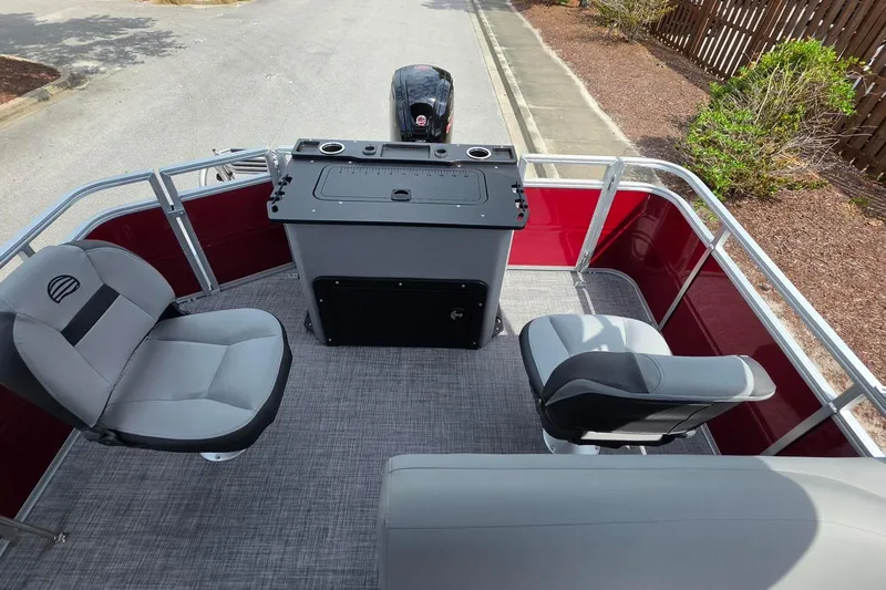 Slide: The Image of 2026 Sun Tracker SportFish 20 DLX pontoon boat interior with seating and control console. - 17