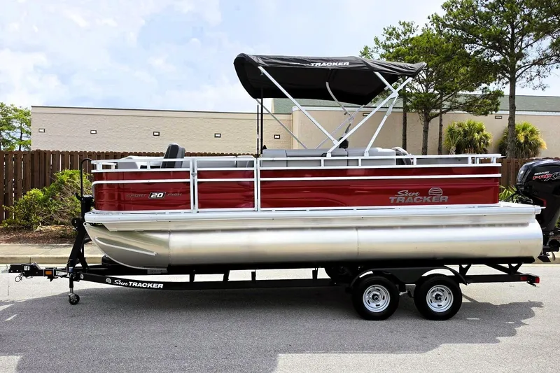 Slide: The Image of 2026 Sun Tracker SportFish 20 DLX pontoon boat on trailer, parked outdoors. - 8