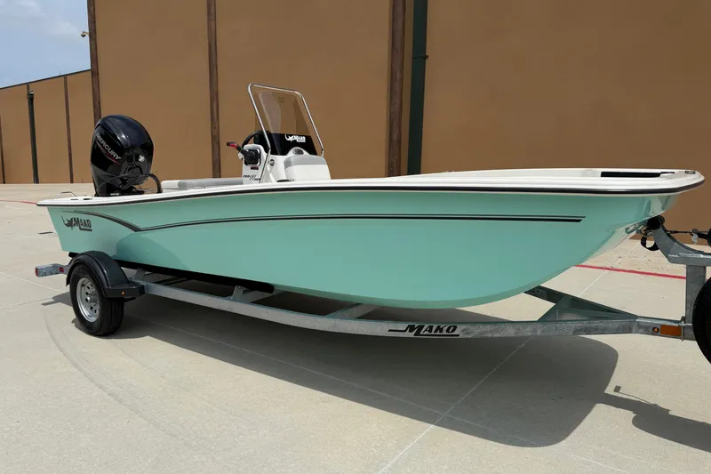 Slide: The Image of A 2026 Mako Pro Skiff 17 CC on a trailer. It features a light blue hull. - 3