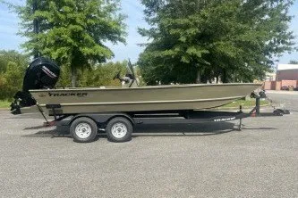 Slide: The Image of 2026 Tracker Grizzly 2072 CC boat on trailer, parked outdoors. - 2
