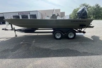 The Image of 2026 Tracker Grizzly 2072 CC boat on trailer in parking lot. - 0