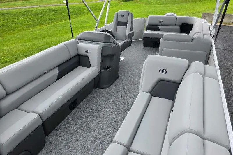 Slide: The Image of 2026 Sun Tracker Party Barge 20 DLX interior with spacious gray seating and modern design. - 8