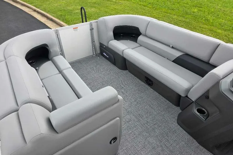 Slide: The Image of 2026 Sun Tracker Party Barge 20 DLX interior with gray seating and carpeted floor. - 4