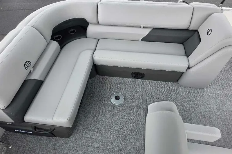 Slide: The Image of 2026 Sun Tracker Party Barge 20 DLX interior with plush seating and cup holders. - 6