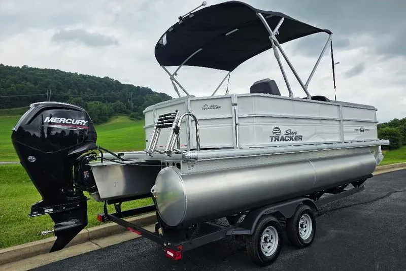 Slide: The Image of 2026 Sun Tracker Party Barge 20 DLX pontoon boat with Mercury engine on trailer. - 2