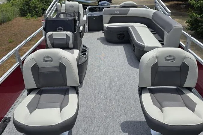 Slide: The Image of 2026 Sun Tracker Bass Buggy 18 DLX pontoon boat interior with gray seating and spacious layout. - 10