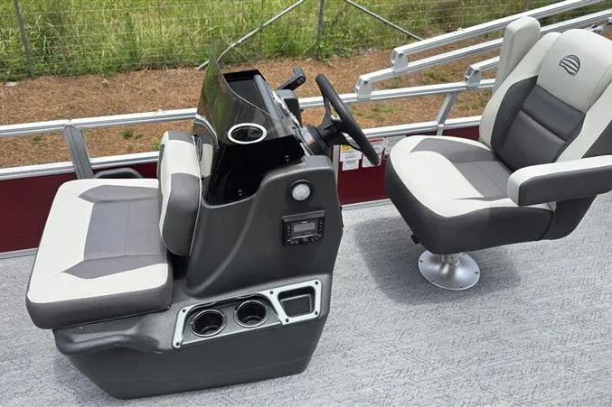 Slide: The Image of 2026 Sun Tracker Bass Buggy 18 DLX boat interior with steering console and seating. - 6