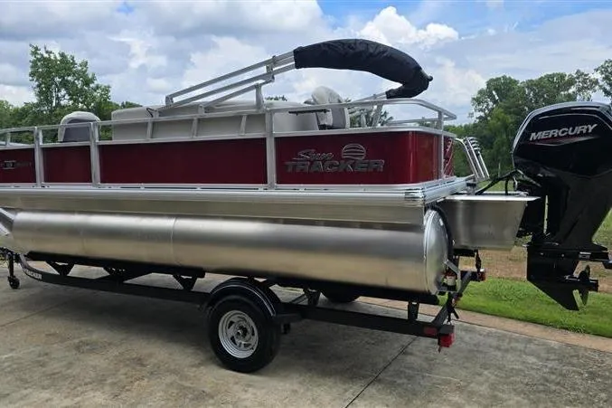 Slide: The Image of 2026 Sun Tracker Bass Buggy 18 DLX pontoon boat with Mercury engine on trailer. - 3