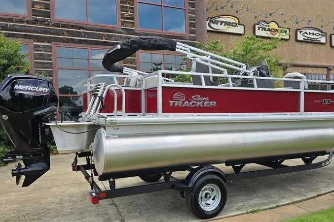 Slide: The Image of 2026 Sun Tracker Bass Buggy 18 DLX pontoon boat with Mercury engine on trailer. - 19