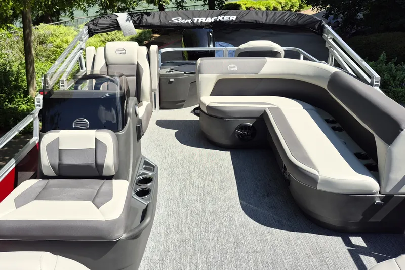 Slide: The Image of 2026 Sun Tracker Bass Buggy 18 DLX pontoon boat interior with plush seating and modern design. - 10