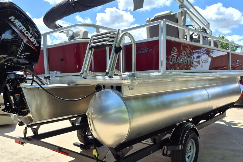 Slide: The Image of 2026 Sun Tracker Bass Buggy 18 DLX pontoon boat with Mercury engine, on trailer. - 5