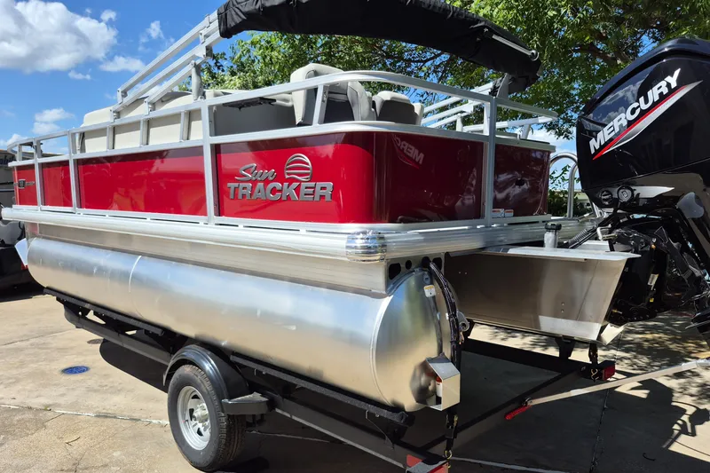 Slide: The Image of 2026 Sun Tracker Bass Buggy 18 DLX pontoon boat with Mercury engine on trailer. - 7