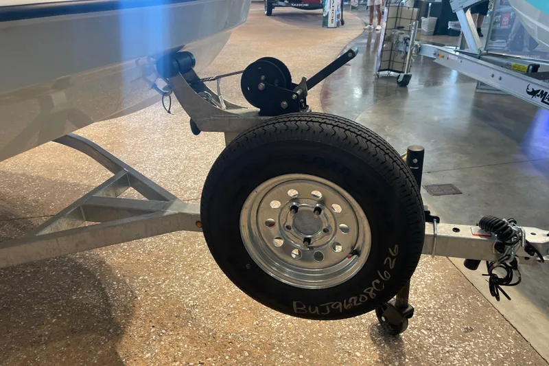 Slide: The Image of Trailer hitch and spare tire of a 2026 Mako Pro Skiff 17 CC boat. - 5