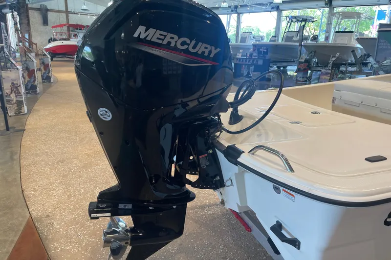 Slide: The Image of 2026 Mako Pro Skiff 17 CC with Mercury outboard motor in showroom. - 3