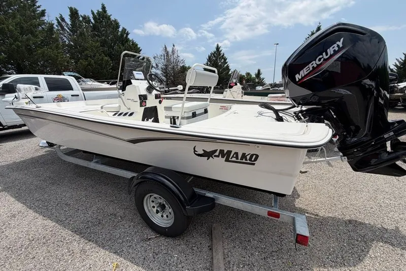 Slide: The Image of 2026 Mako Pro Skiff 17 CC boat on trailer with Mercury engine, parked outdoors. - 51