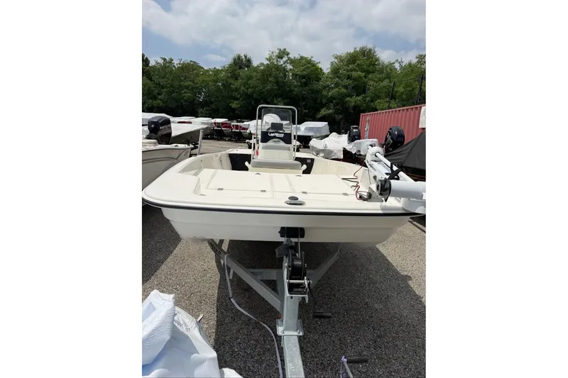 Slide: The Image of 2026 Mako Pro Skiff 17 CC boat on trailer, parked outdoors. - 43