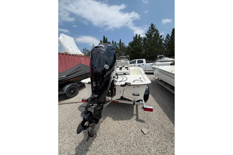 Slide: The Image of 2026 Mako Pro Skiff 17 CC boat with outboard motor, parked outdoors. - 50