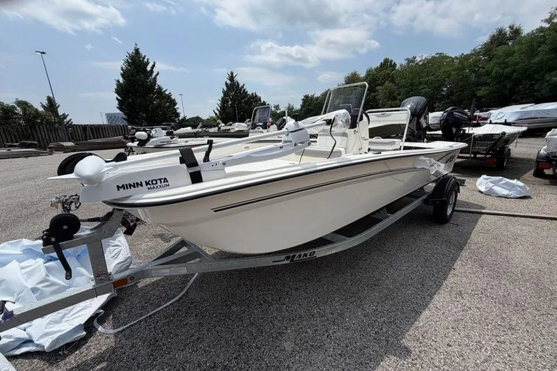 Slide: The Image of 2026 Mako Pro Skiff 17 CC boat on trailer, equipped with Minn Kota Maxxum motor. - 8