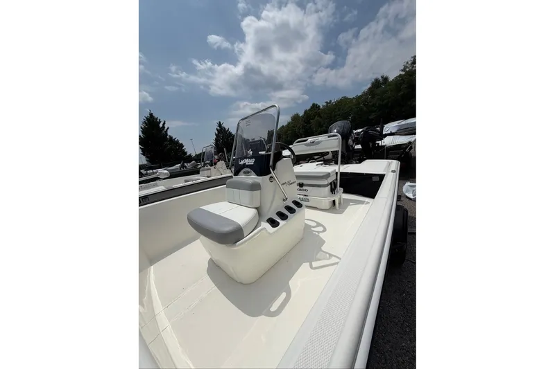 Slide: The Image of 2026 Mako Pro Skiff 17 CC boat with center console under a partly cloudy sky. - 47