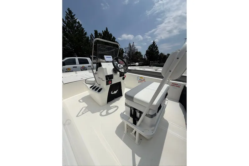 Slide: The Image of The image shows the cockpit of a Mako Pro Skiff 17 CC with a helm console and seating. - 44