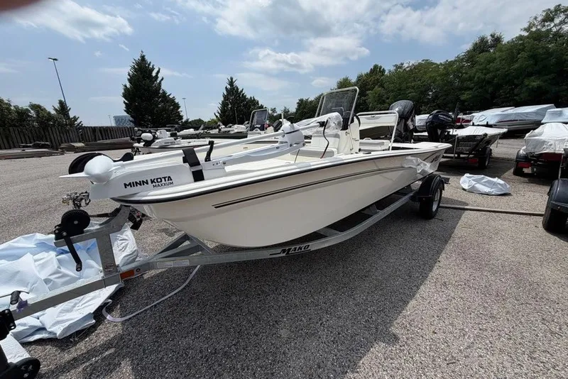 Slide: The Image of 2026 Mako Pro Skiff 17 CC boat on trailer, equipped with Minn Kota motor. - 45