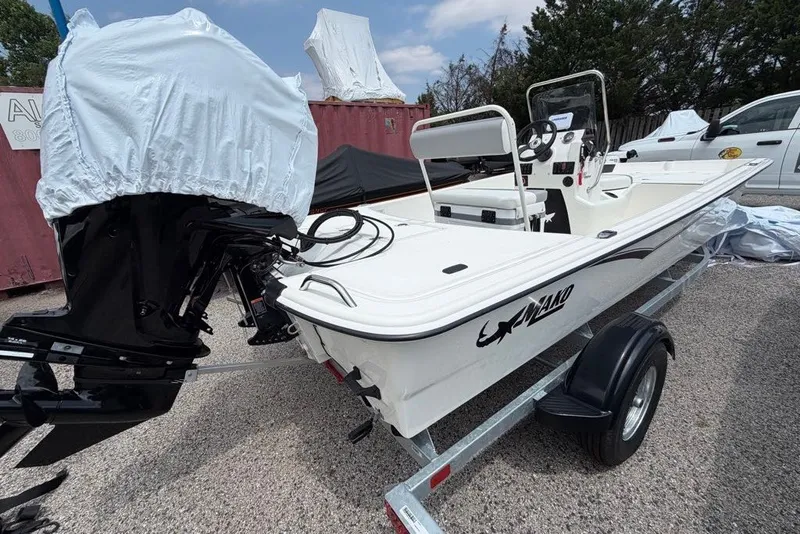 Slide: The Image of 2026 Mako Pro Skiff 17 CC boat on trailer, featuring covered outboard motor. - 49