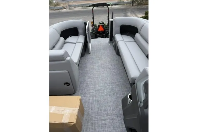 Slide: The Image of 2026 Sun Tracker Party Barge 20 DLX interior with gray seating and flooring. - 6
