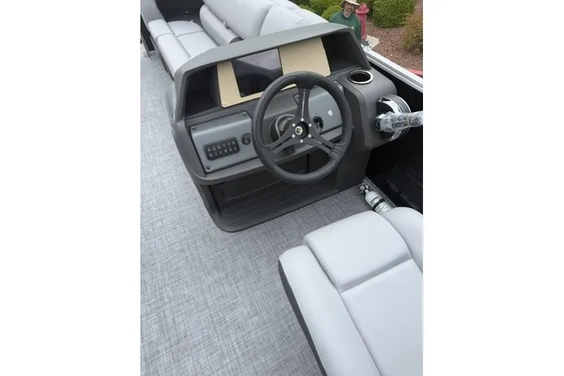 Slide: The Image of 2026 Sun Tracker Party Barge 20 DLX interior with steering wheel and seating. - 8