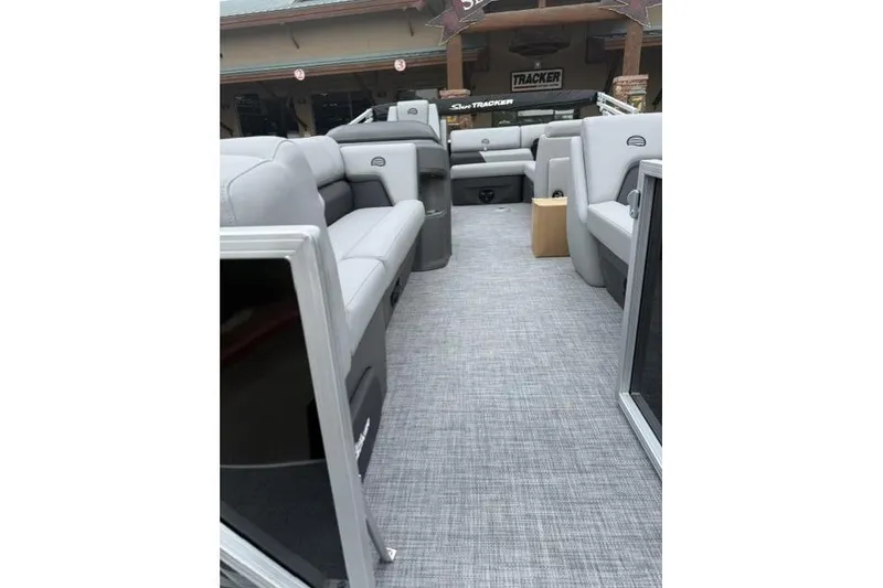 Slide: The Image of 2026 Sun Tracker Party Barge 20 DLX interior with gray seating and flooring. - 5