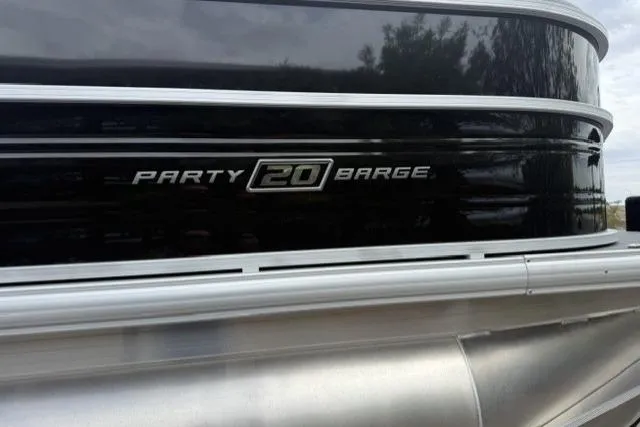 Slide: The Image of 2026 Sun Tracker Party Barge 20 DLX pontoon boat, sleek black exterior detail. - 2