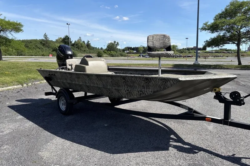 The Image of 2026 Tracker Grizzly 1754 SC boat on trailer in sunny parking lot. - 0