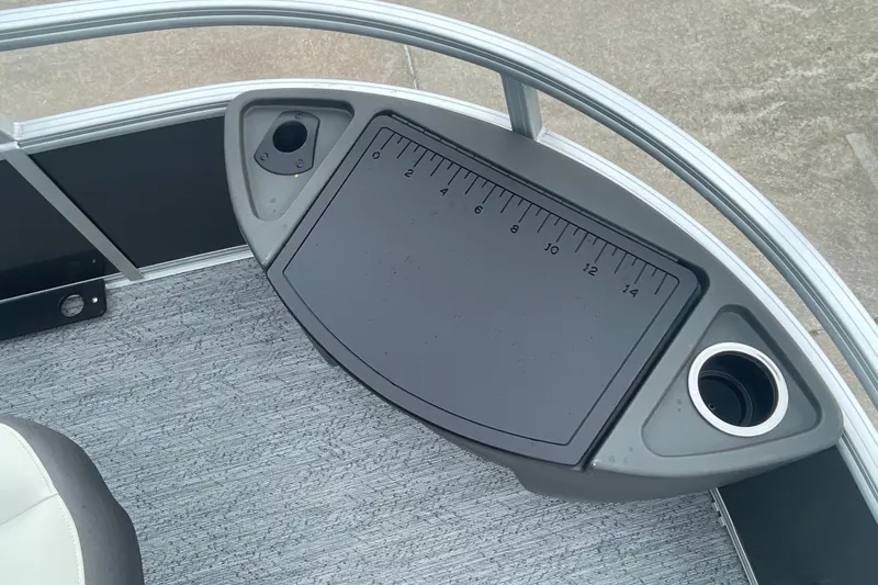 Slide: The Image of 2026 Sun Tracker Bass Buggy 18 DLX boat deck with measuring board and cup holder. - 25