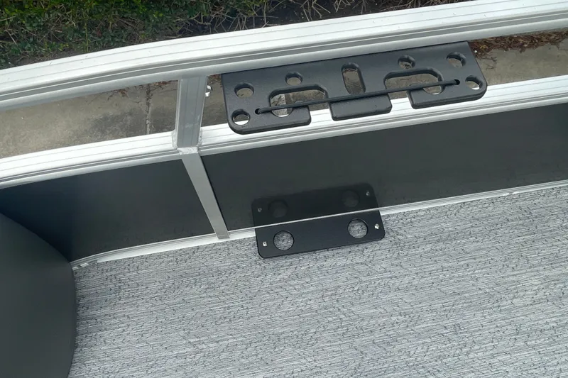 Slide: The Image of 2026 Sun Tracker Bass Buggy 18 DLX boat interior with metal railing and mounting bracket. - 24