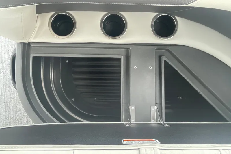 Slide: The Image of 2026 Sun Tracker Bass Buggy 18 DLX storage compartment with cup holders. - 18
