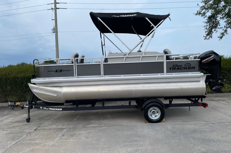 The Image of 2026 Sun Tracker Bass Buggy 18 DLX pontoon boat on trailer, side view. - 0