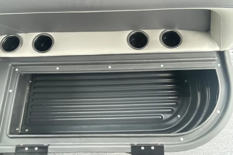 Slide: The Image of Interior storage compartment of 2026 Sun Tracker Bass Buggy 18 DLX with cup holders. - 17