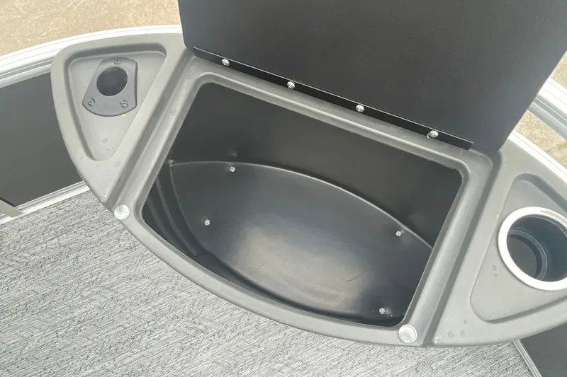 Slide: The Image of Storage compartment and cup holders on 2026 Sun Tracker Bass Buggy 18 DLX boat. - 26