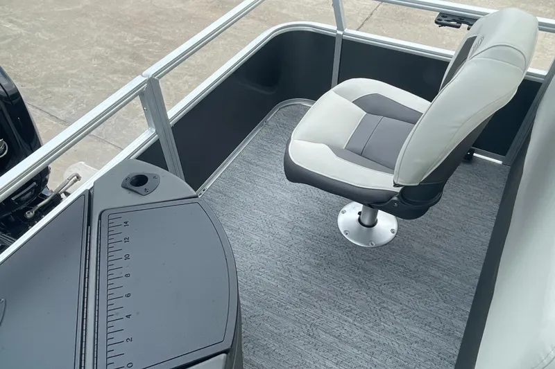 Slide: The Image of 2026 Sun Tracker Bass Buggy 18 DLX boat interior with swivel seat and measuring board. - 15