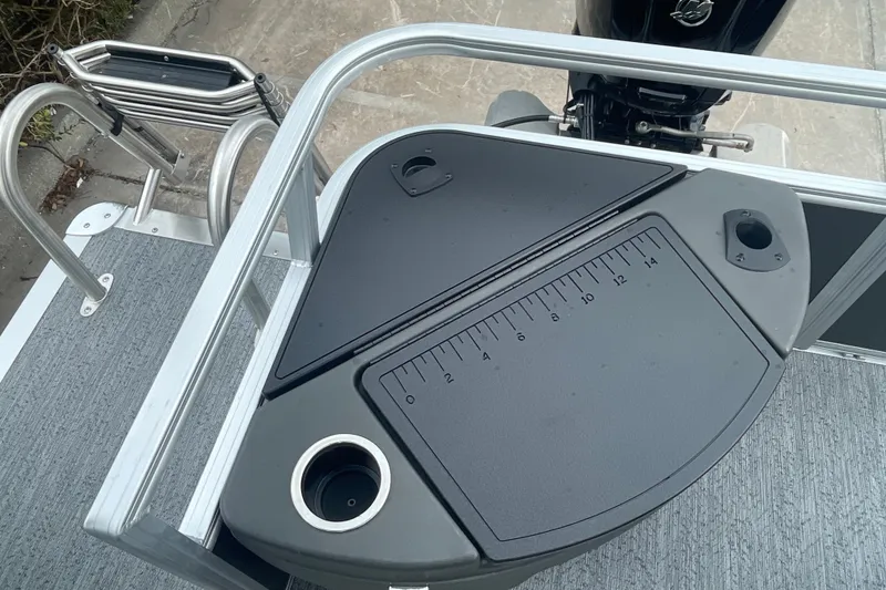 Slide: The Image of 2026 Sun Tracker Bass Buggy 18 DLX fishing platform with measuring board and cup holders. - 20