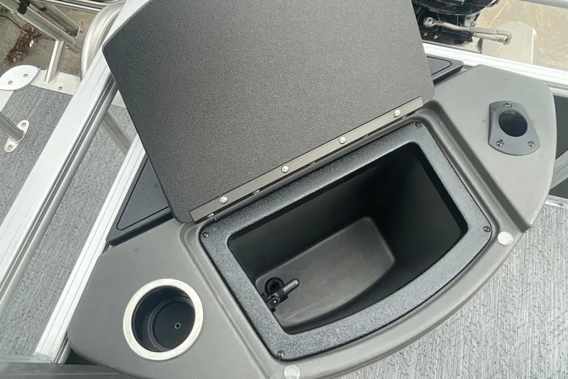 Slide: The Image of 2026 Sun Tracker Bass Buggy 18 DLX storage compartment with cup holder on deck. - 21